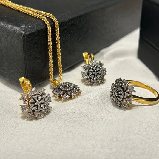 Jewelry set with gold and silver earrings and a ring on a light surface. GOLDPLATED COMBO SET 