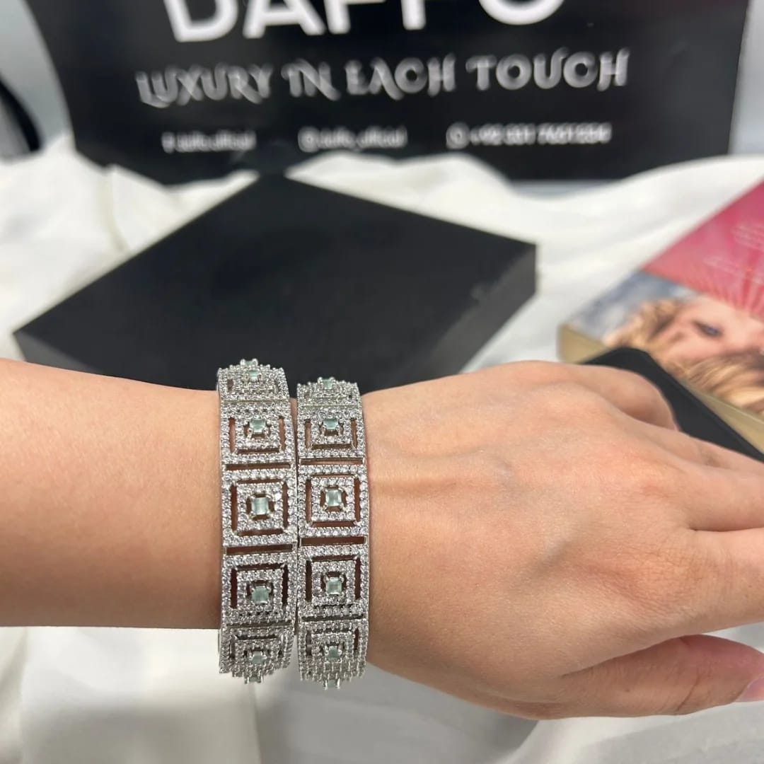 Silver bracelet on a wrist with a blurred background