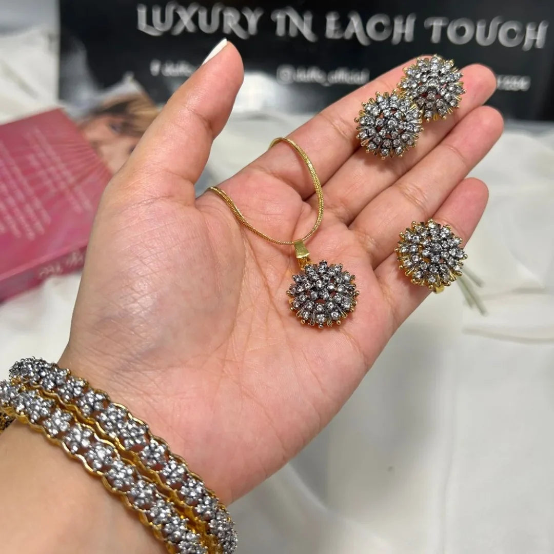 Hand holding a gold bracelet and earrings with 'Luxury in Each Touch' text in the background